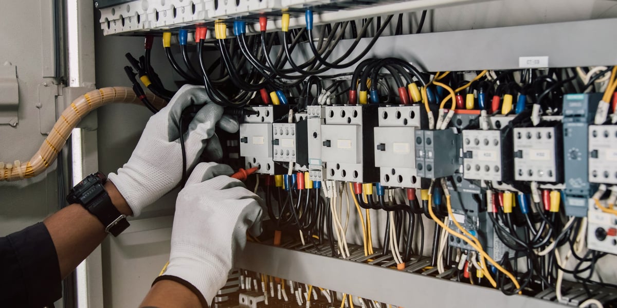 Electrician engineer performing tests on electrical installations and relay protection wiring — CN Electrical permit-compliant EV charger installation in Chilliwack, BC