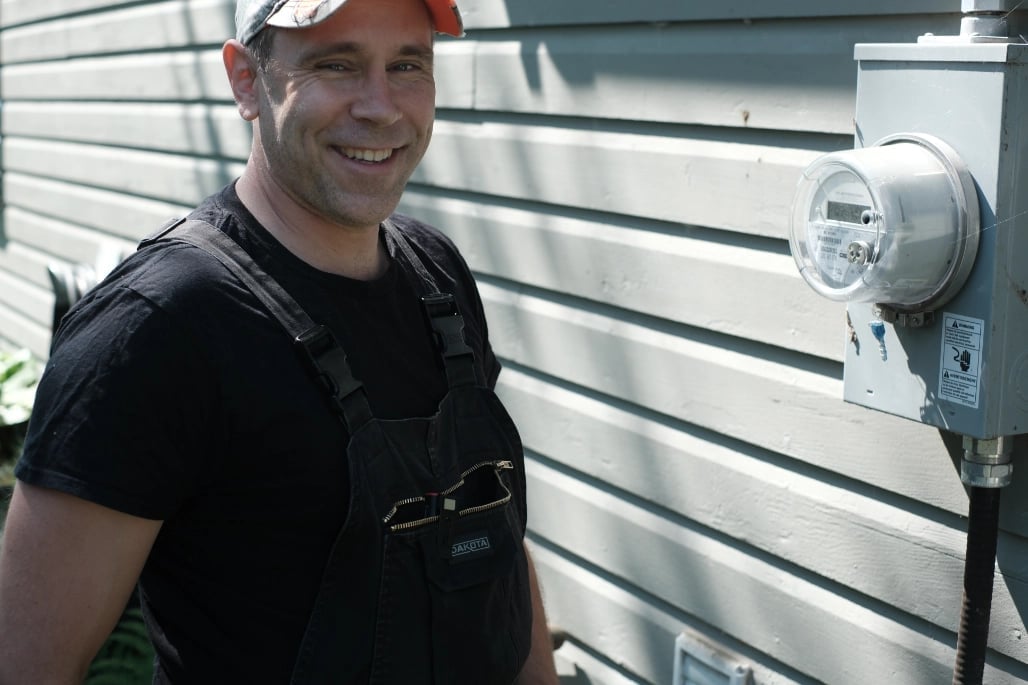 Professional electrician in safety vest inspecting electrical meter — CN Electrical serving Hope and Fraser Canyon homes and businesses